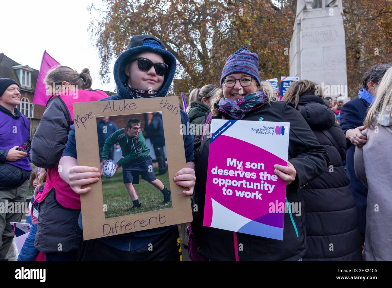 Ein Kind mit Down-Syndrom sah, wie es mit seinen Eltern Plakate hielt und sagte: "Mehr gleich als anders", und "Mein Sohn verdient die Gelegenheit zu arbeiten".der Down-Syndrom-Gesetzentwurf, der von dem Abgeordneten Liam Fox vorgetragen und von Parlamentsabgeordneten auf verschiedenen Parteien gesponsert wurde, befindet sich derzeit in der Lesephase von 2nd. Wenn die Krankheit angenommen wird, werden Menschen mit Down-Syndrom rechtlich als Minderheitsgruppe anerkannt, was eine Verbesserung der Bedingungen für die von der Krankheit Betroffenen in Bezug auf soziale Betreuung, Entstigmatisierung, Bildung und Beschäftigung bedeuten würde. Die Down's Syndrome Policy Group organisierte eine Veranstaltung, um Unterstützung für den Tod von Th zu zeigen Stockfoto