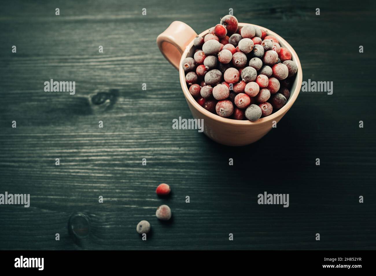 Tasse mit frischen gefrorenen Beeren Stockfoto