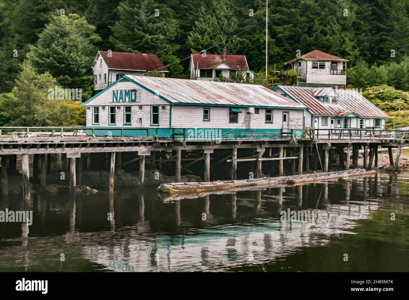 Verlassene Häuser und Gebäude stehen am Ufer und an der Promenade in Namu, einer historischen ehemaligen Stadt mit Konservenfabrikant und Fischpflanzen in der Inside Passage von British Columbia (2009). Stockfoto