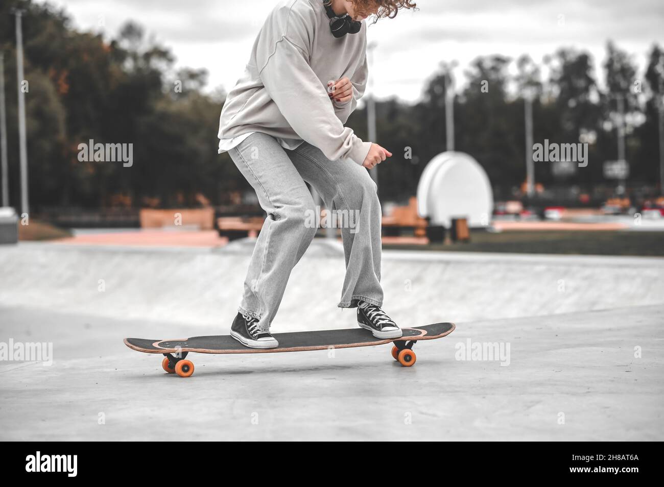 Mädchen mit Beinen an den Knien gebeugt Reiten Skateboard Stockfoto