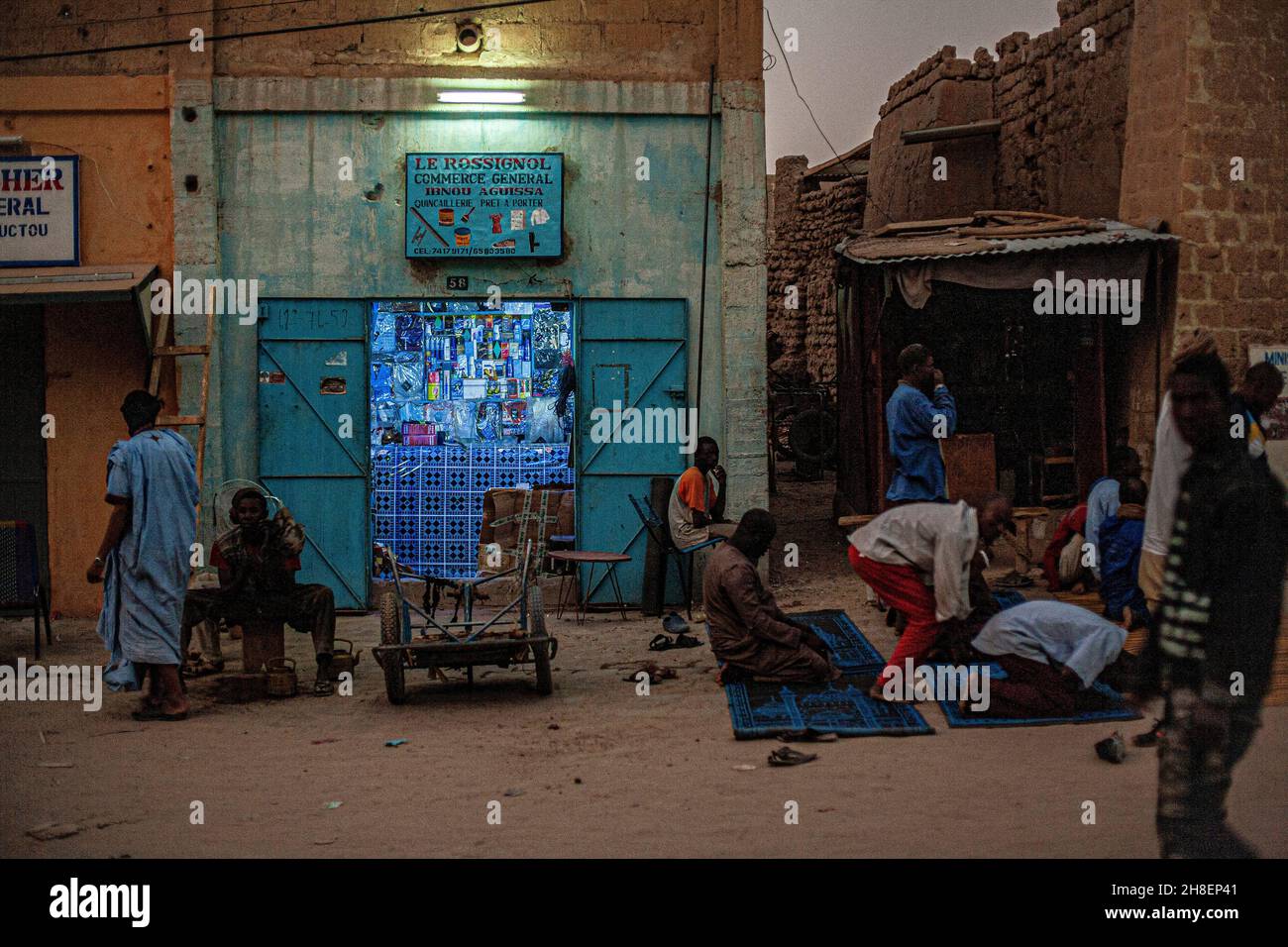 Muslimische Gläubige knien vor dem Laden in Timbuktu, Mali Westafrika, auf Gebetsteppichen nieder. Stockfoto