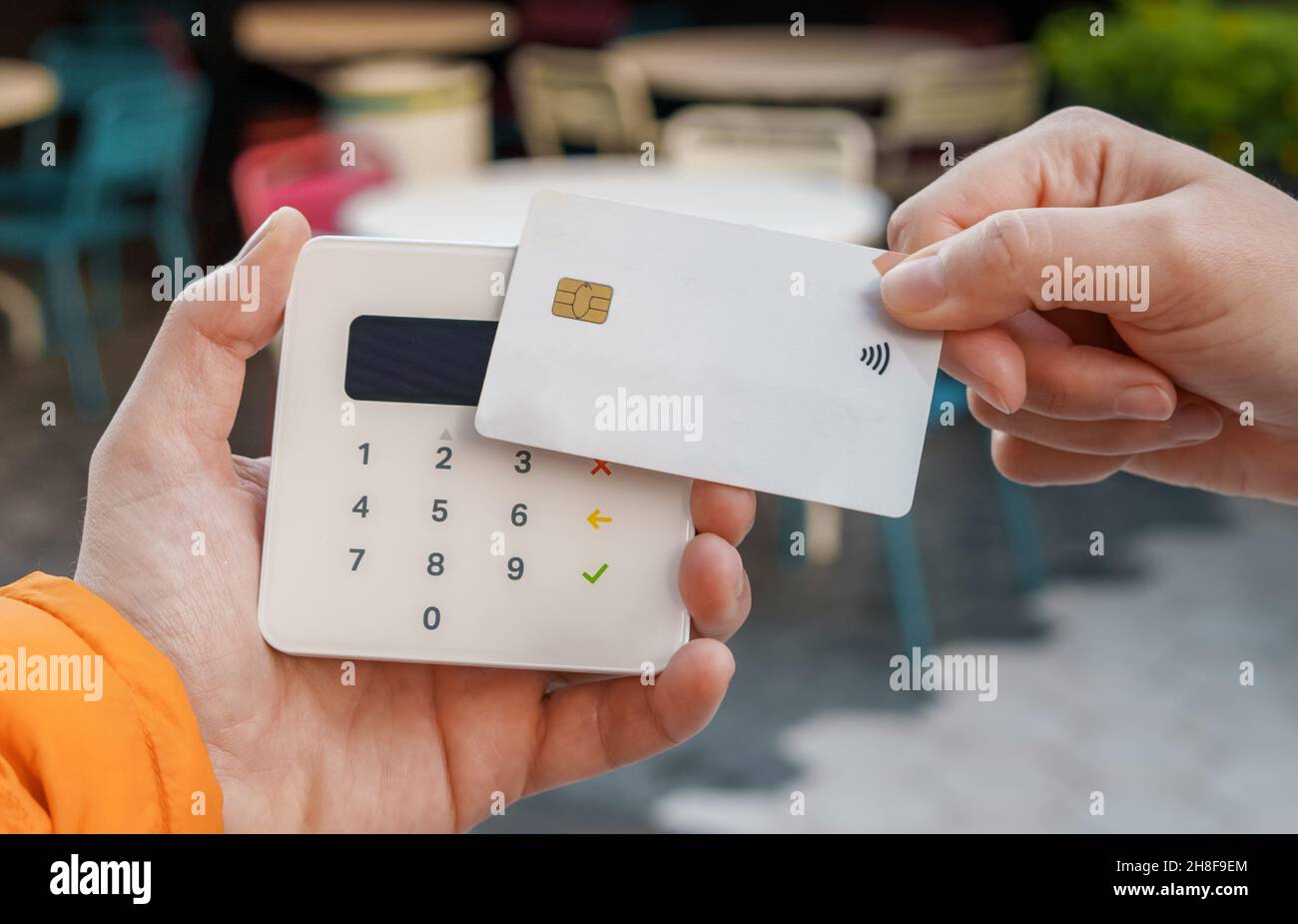 Crop unkenntlich weiblich mit Plastikkarte machen Kauf für Bestellung am POS-Terminal in Outdoor-Café in der Stadt Stockfoto