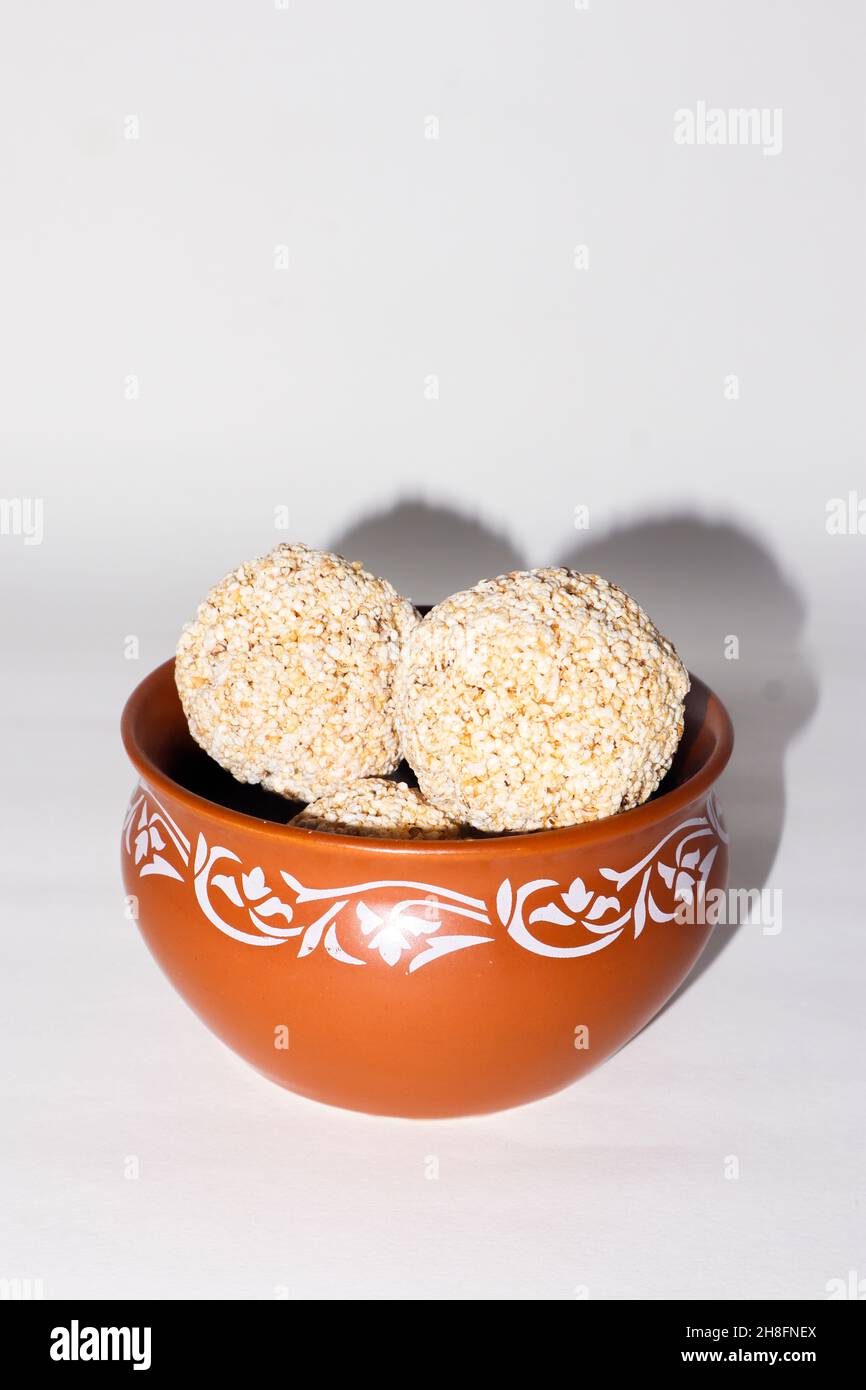 Indische Süßigkeit für traditionelles Festival makar sankranti :Rajgira laddu aus Amaranth Samen in Schale auf weißem Hintergrund Stockfoto