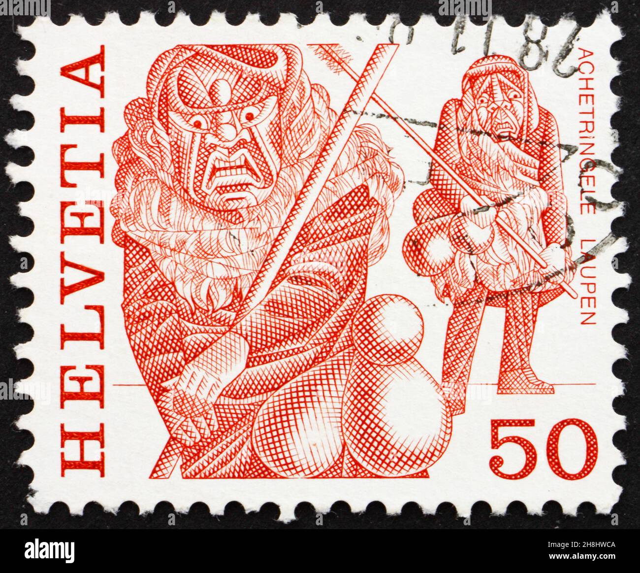 SCHWEIZ - UM 1977: Eine in der Schweiz gedruckte Briefmarke zeigt Maskierte Männer, Achetringelen Laupen, Bern, Volksbräuche, um 1977 Stockfoto