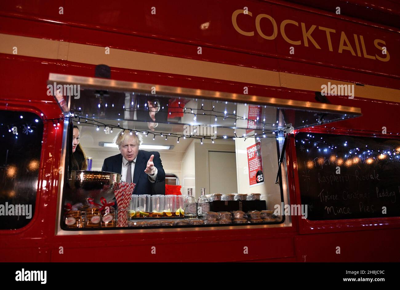 Premierminister Boris Johnson spricht mit einem Standhalter an Bord eines umgebauten Londoner Busses, der Cocktails verkauft, während er einen britischen Lebensmittel- und Getränkemarkt besucht, der in der Downing Street, London, eingerichtet wurde. Bilddatum: Dienstag, 30. November 2021. Stockfoto