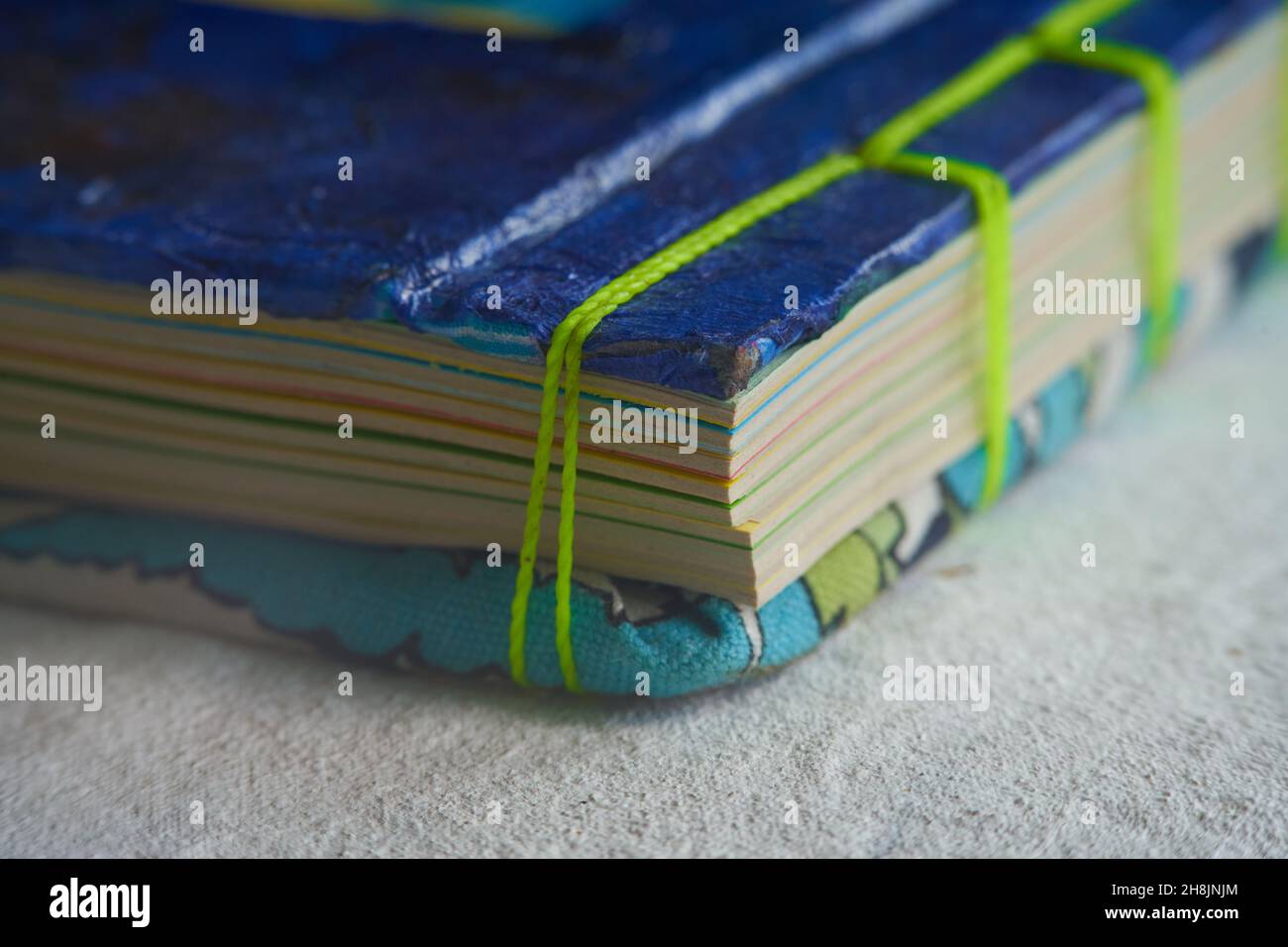 Nahaufnahme-Schnapsbuch mit recycelten Papierblättern und handgefertigter Bindung mit Webfaden Stockfoto