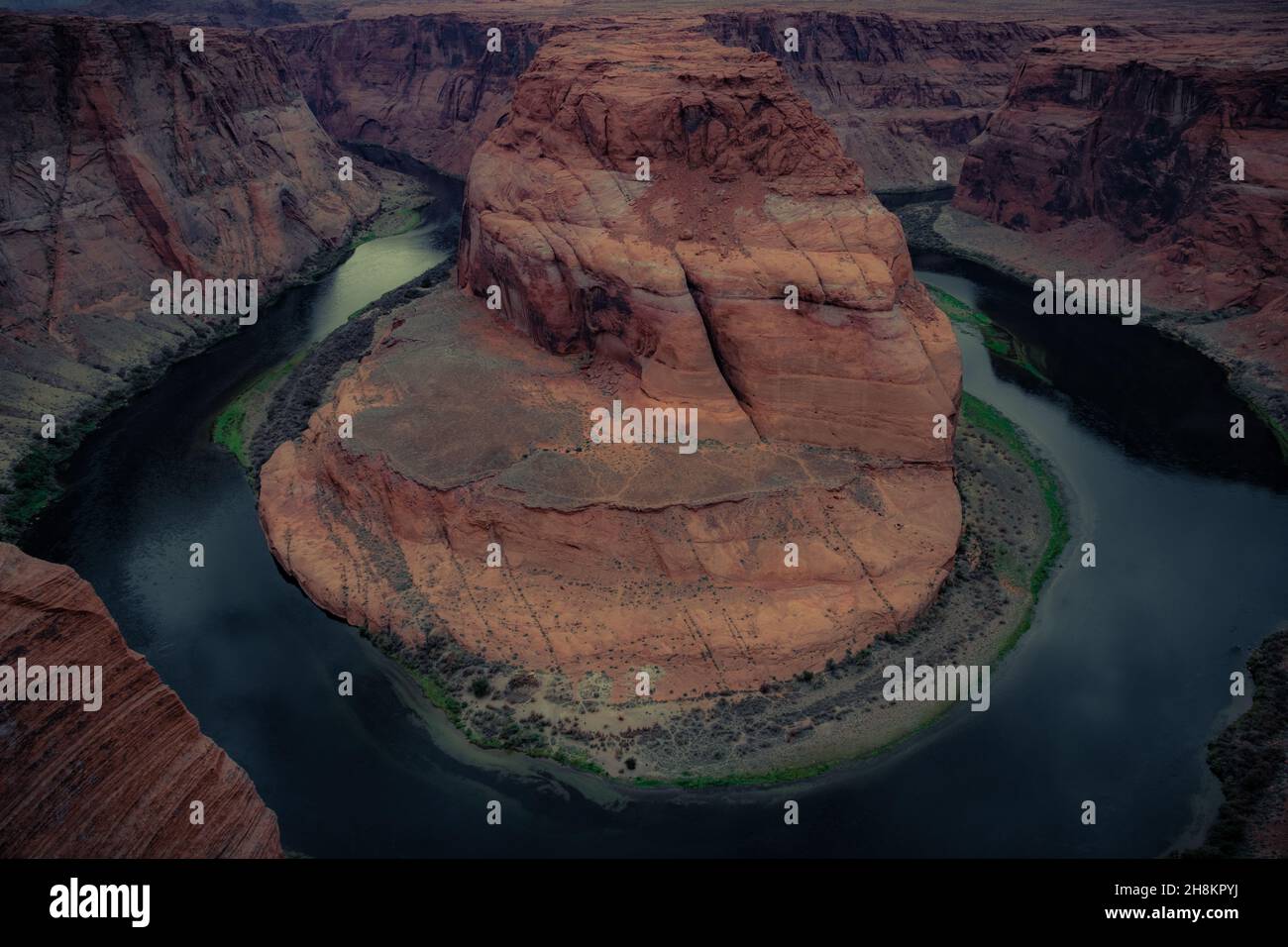 Blick auf das Horseshoe Bend, ein hufeisenförmiges, eingeschnitztes Mäander des Colorado River, Sturmwolken am Himmel, Page, Arizona, USA Stockfoto