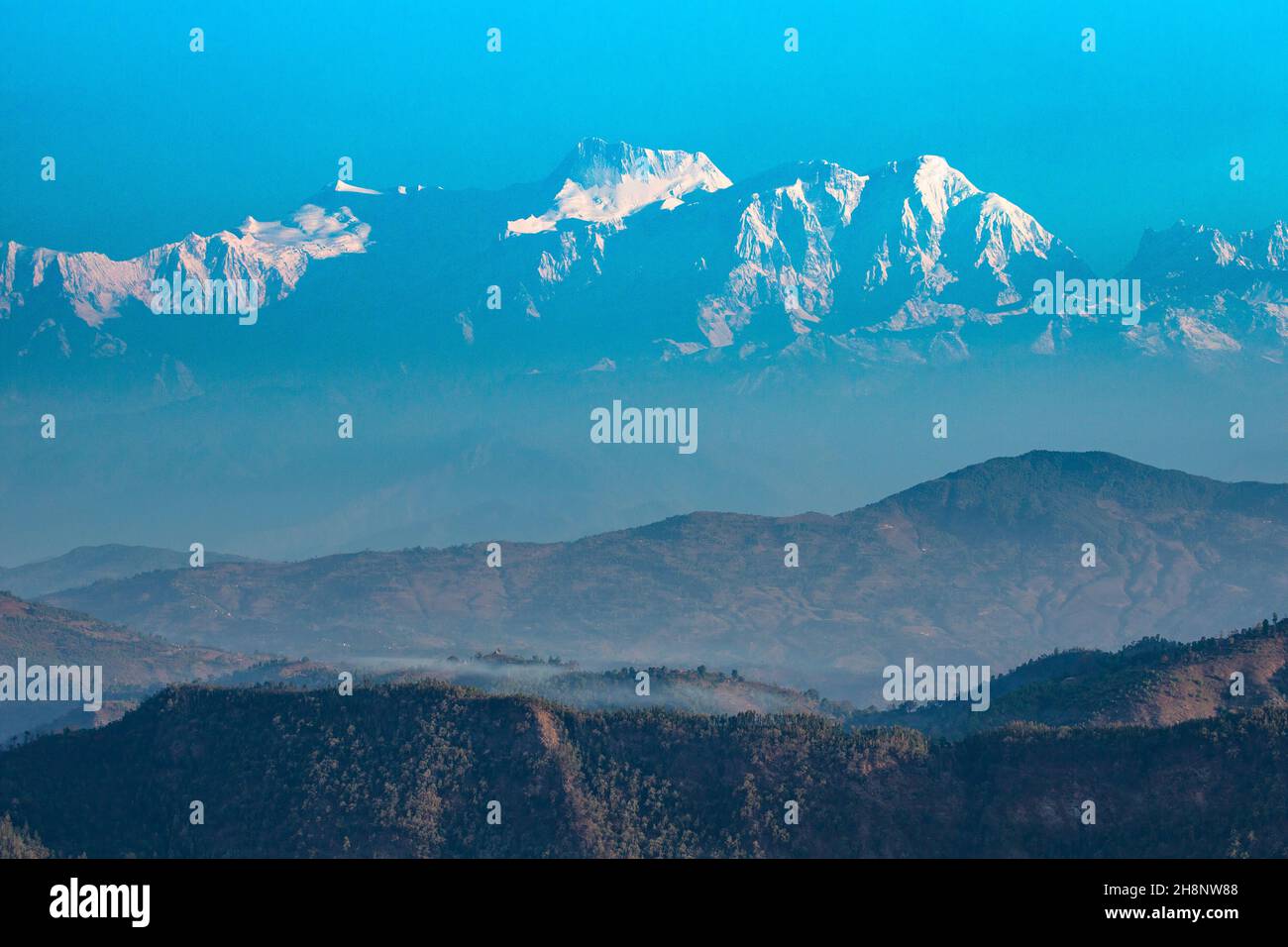 Erstes Licht auf der Annapurna Himal mit den Himalaya-Ausläufern im Vordergrund. Von Bandipur aus gesehen, Nepal. Stockfoto