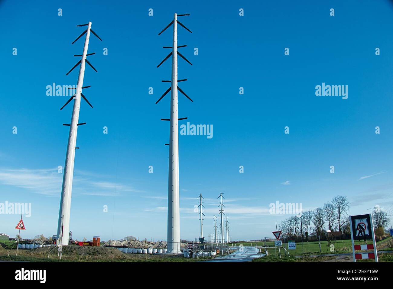 Reihe neuer Strommasten in der Provinz Groningen, Niederlande, im Bau Stockfoto