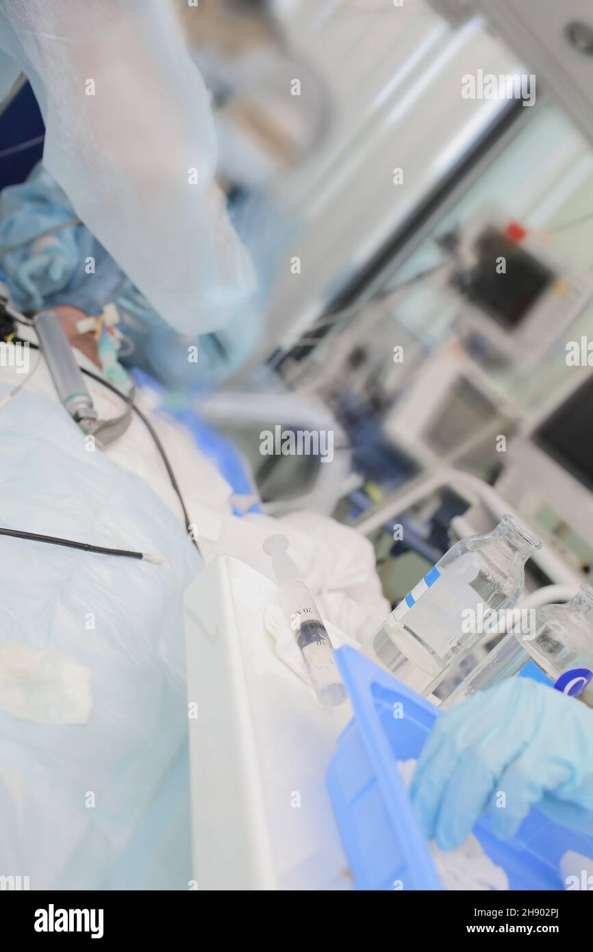 Medizinisches Team, das mit dem Patienten auf der modern ausgestatteten Intensivstation arbeitet. Stockfoto