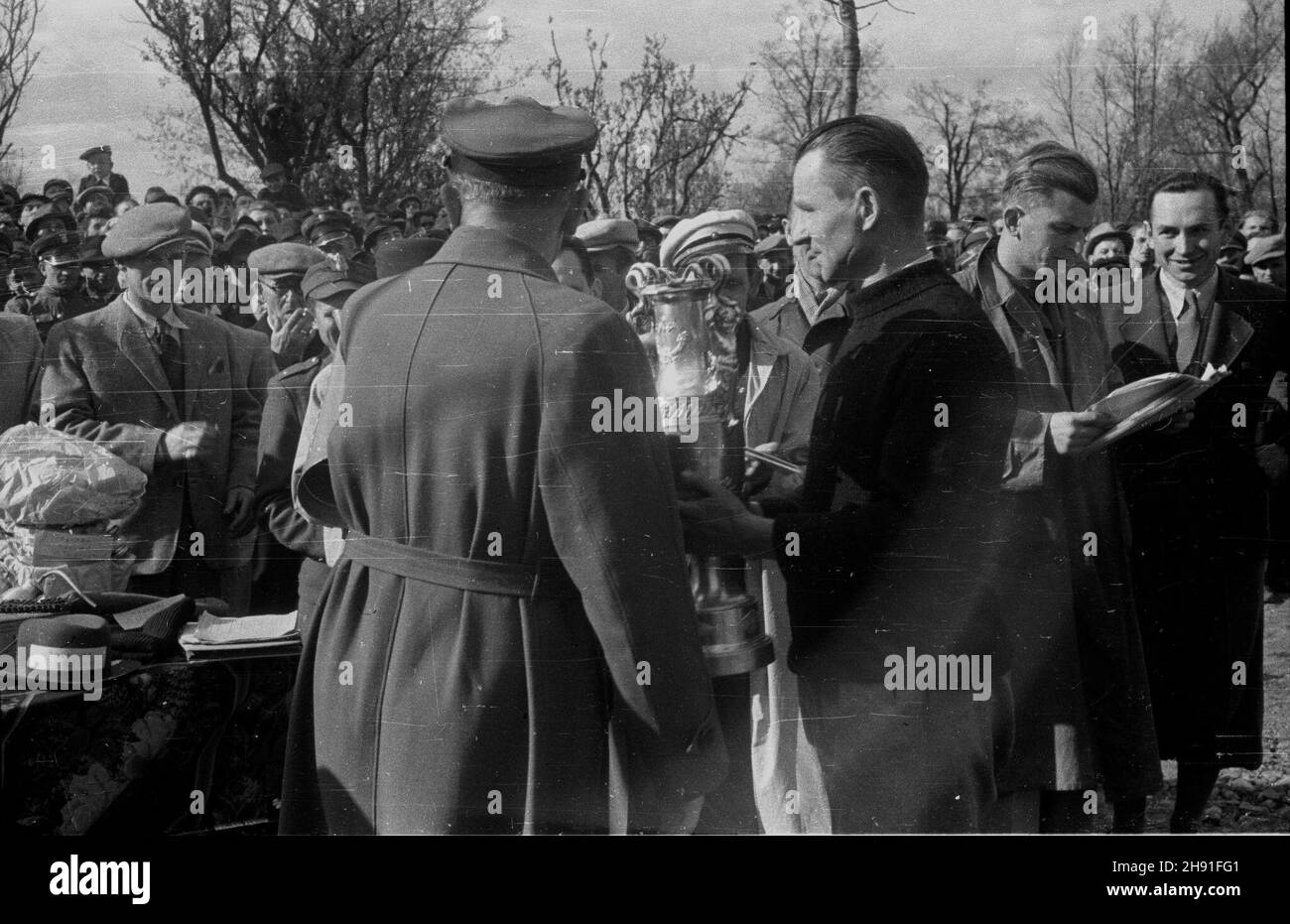 Warszawa, 1947-04-27. Wyœcig kolarski w parku Skaryszewskim o puchar ufundowany przez komendanta milicji p³k. Józefa Konarzewskiego, zorganizowany przez Milicyjny Klub Sportowy. NZ. p³k Konarzewski (ty³em) wrêcza nagrotty zwyciêzcy biegu Marianowi RzeŸnickiemu z Pocztowego Klubu Sportowego. wb PAP Warschau, 27. April 1947. Ein Radrennen um den Pokal, finanziert vom Milizkommandanten col. Jozef Konarzewski, organisiert vom Miliz Sports Club und im Skaryszewski Park. Abgebildet: col. Konarzewski überreicht Auszeichnungen an die Sieger des Rennens. wb PAP Stockfoto