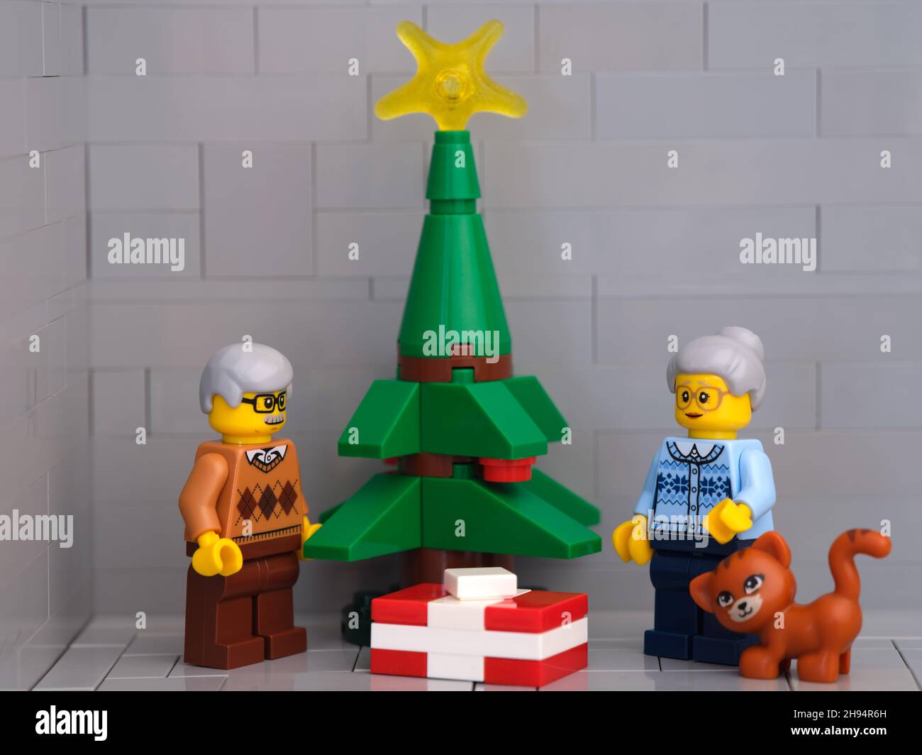 Tambow, Russische Föderation - 01. Dezember 2021 Ein Lego-Großvater, eine Großmutter und eine Katze Minifiguren stehen neben einem Weihnachtsbaum mit Geschenken Stockfoto