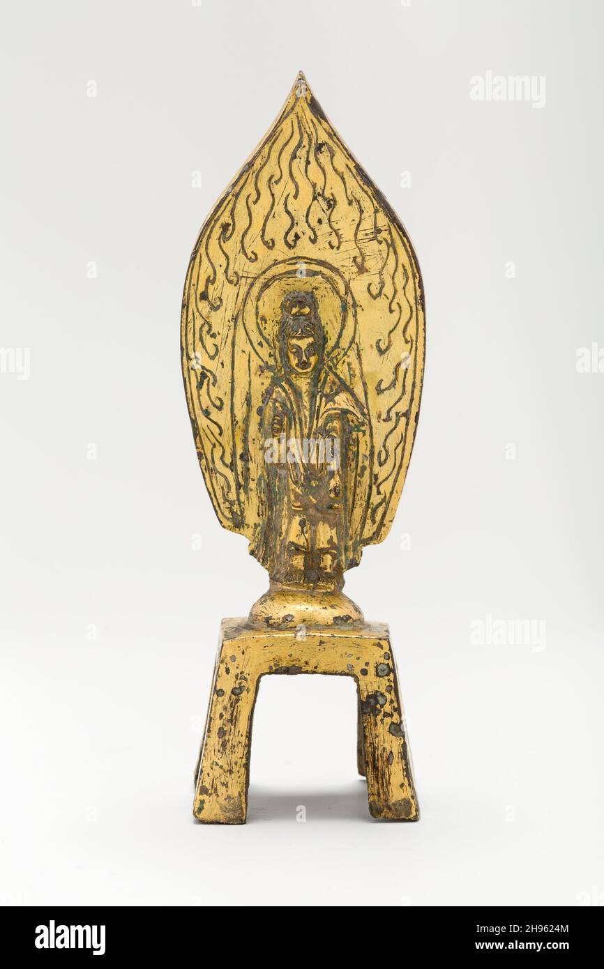 Guanyin (Avalokiteshvara) steht vor der flammenden Aureole und hält eine Wasserflasche, östliche oder westliche Wei-Dynastie, ca. Mitte des 5th. Jahrhunderts (umgewidmet 594). Stockfoto