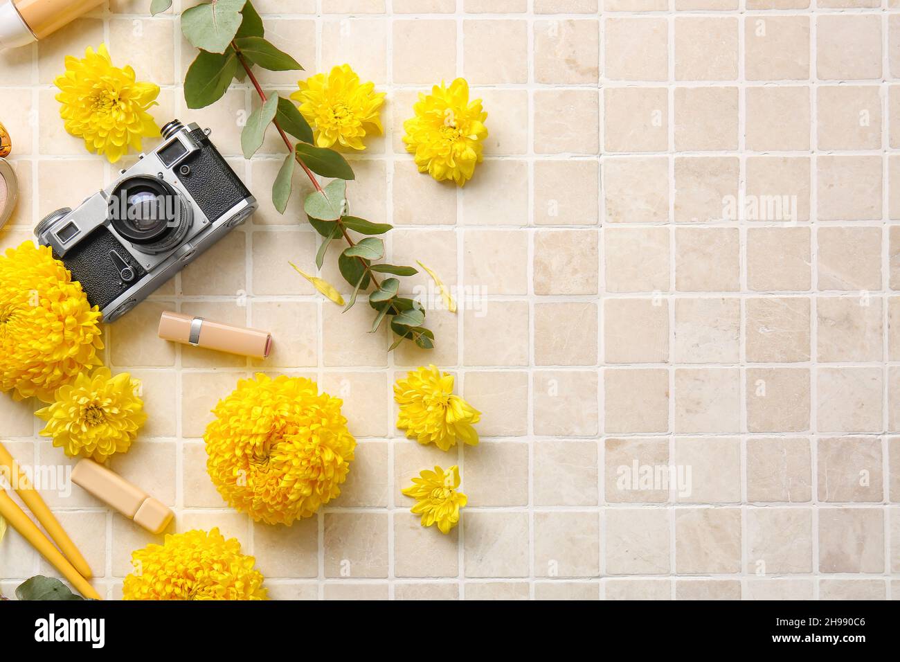 Dekorative Kosmetik, Retro-Fotokamera und gelbe Chrysanthemen Blumen auf hellem Hintergrund Stockfoto