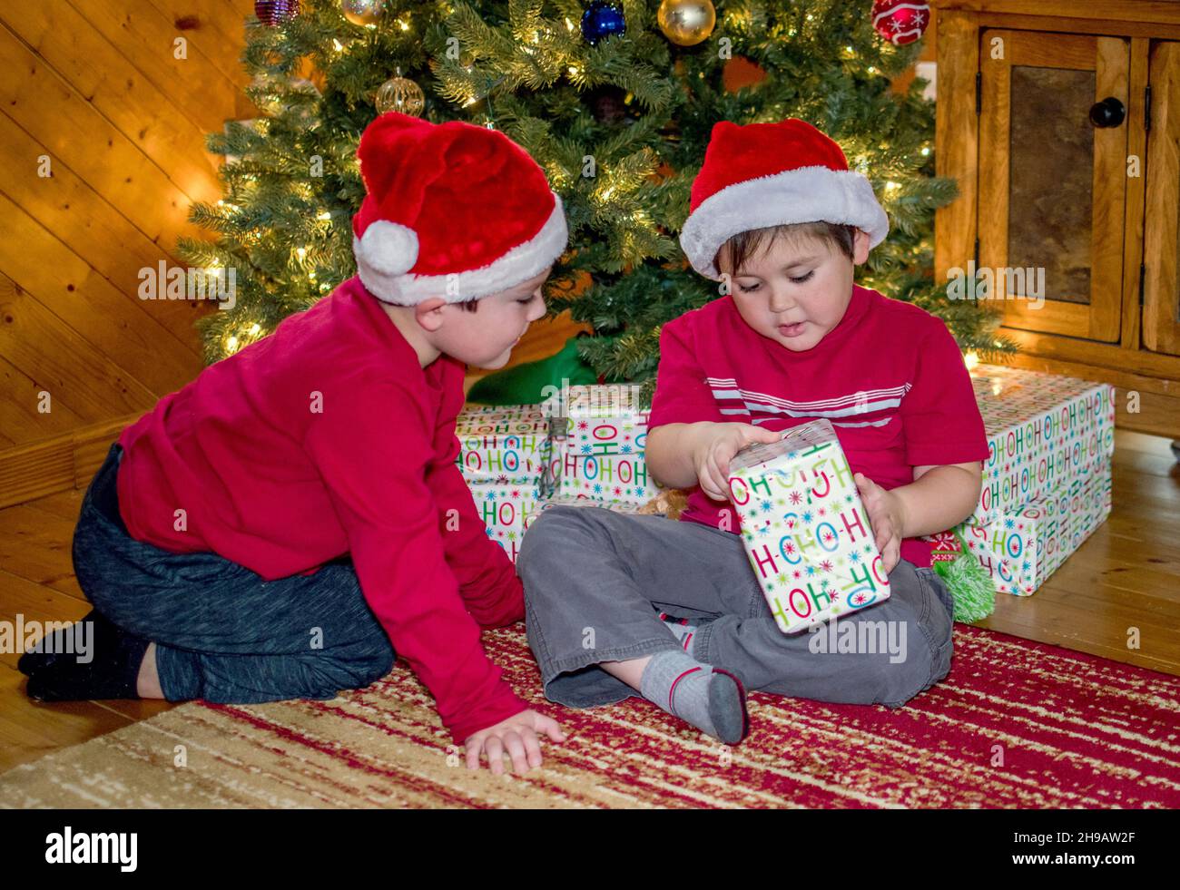 Brüder öffnen Geschenke Weihnachtsmorgen Stockfoto