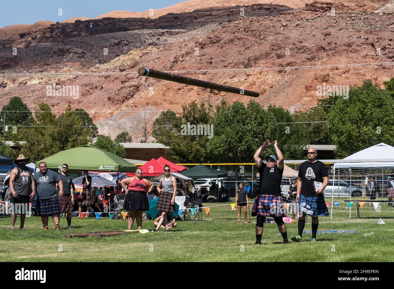 Ein Konkurrent tosses the caber in einem Wettbewerb auf einem schottischen Festival in Utah. Stockfoto