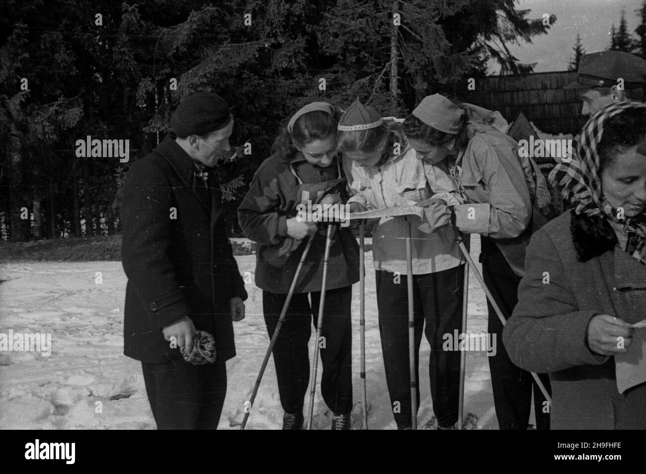 Zakopane, 1948-02-02. Mistrzostwa Polski Juniorów w konkurencjach narciarskich. W najwiêkszej po wojnie imprezie sportowej uczestniczy³o Ponad 650 zawodników. NZ. Uczestniczki biegu podczas postoju na punkcie kontrownym sprawdzaj¹ dalsz¹ trasê. po/gr PAP Zakopane, 2. Februar 1948. Polens Unterzeitmeisterschaft im Skifahren. Die größte Veranstaltung nach WW2 zog mehr als 650 Sportler an. Im Bild: Teilnehmer am Wettbewerb überprüfen die Route am Kontrollpunkt. po/gr PAP Stockfoto