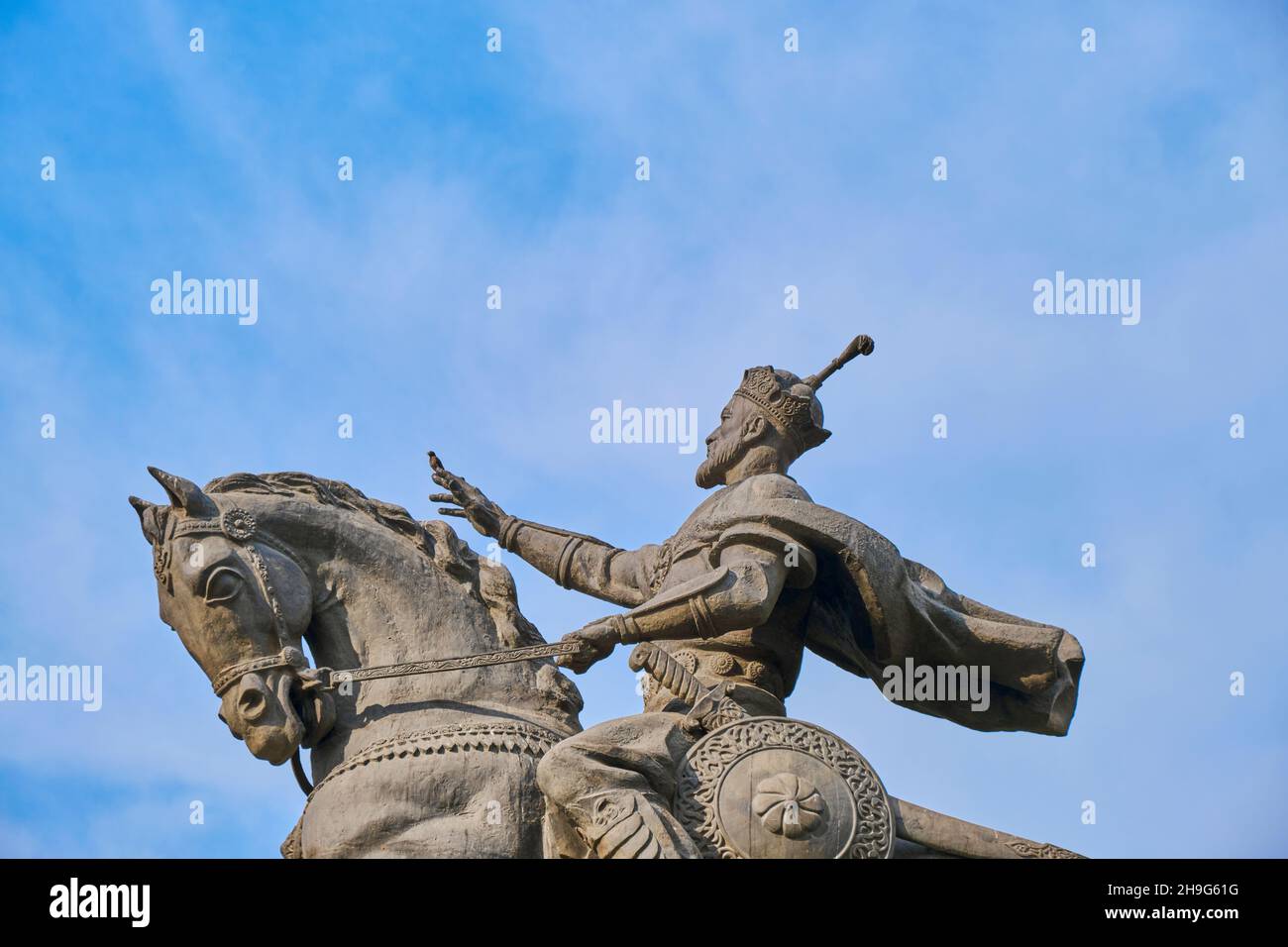 Ein Profil der großen Bronzestatue, Skulptur von Amir Timur auf einem Pferd. Komisch, ein Vogel am Finger. In der Innenstadt von Taschkent, Usbekistan. Stockfoto