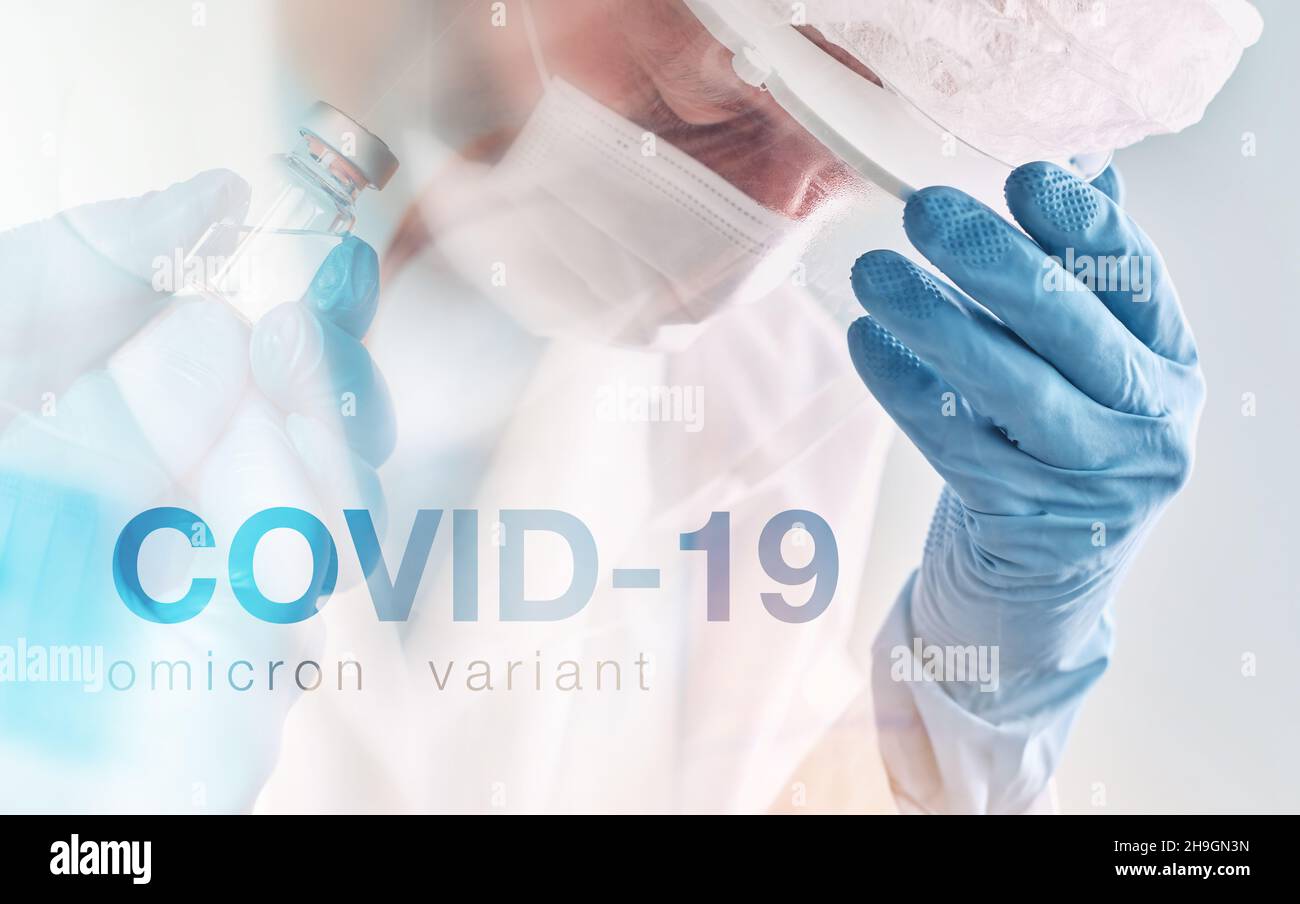 COVID-19 omicron-Variante konzeptuelles Bild mit müdem erschöpften Arzt mit Gesichtsvisier, Schutzhandschuhen und Maske im Krankenhaus Covid-19, Stockfoto