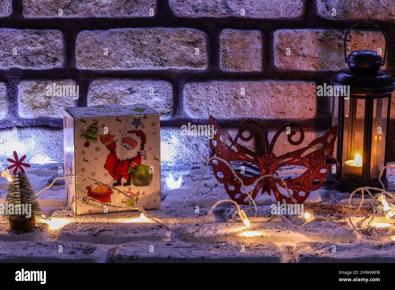 Frohes neues Jahr 2022 und Weihnachtskonzept mit Holznummern, Geschenkbox und Partymaske. Stonewall Thema im Hintergrund. Speicherplatz Kopieren Stockfoto