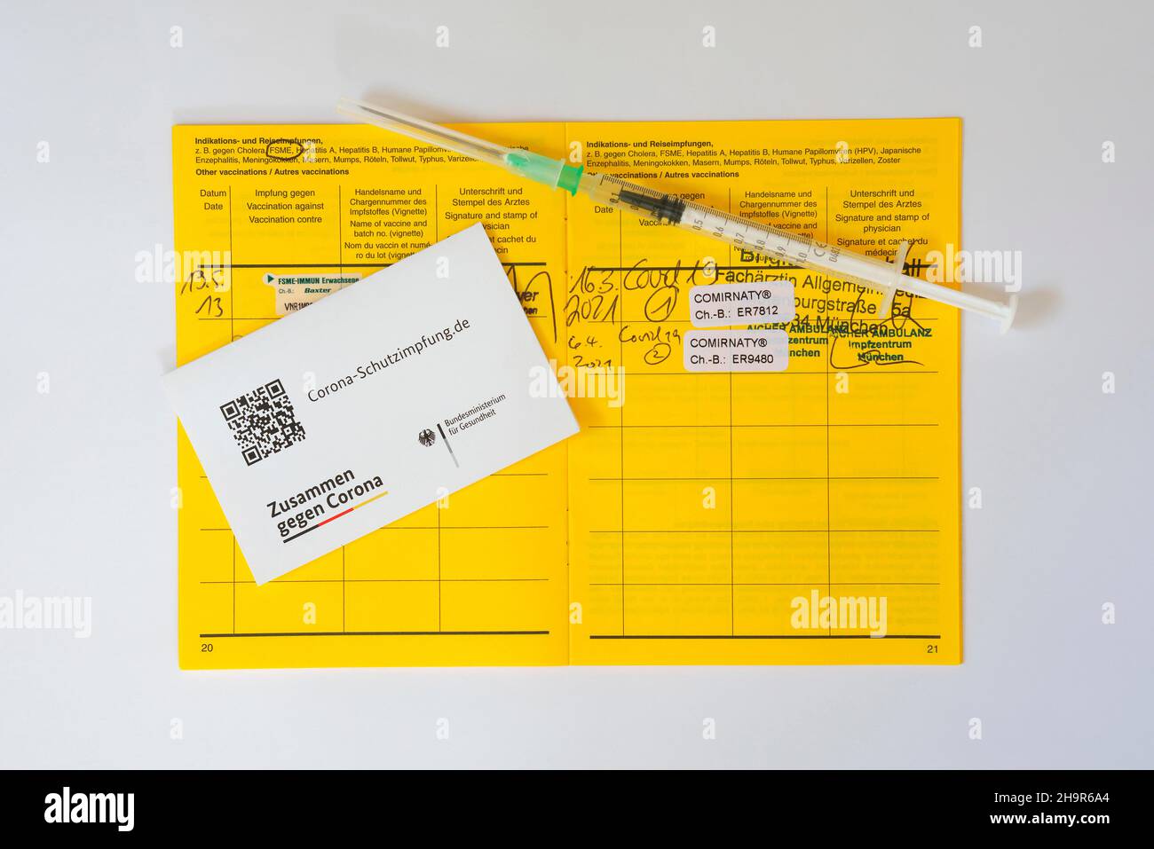 Spritze und Impfpass mit Eintrag für 2 Impfungen mit BioNTech gegen Covid-19, SARS-CoV-2, Corona-Virus, Pandemie, München Stockfoto