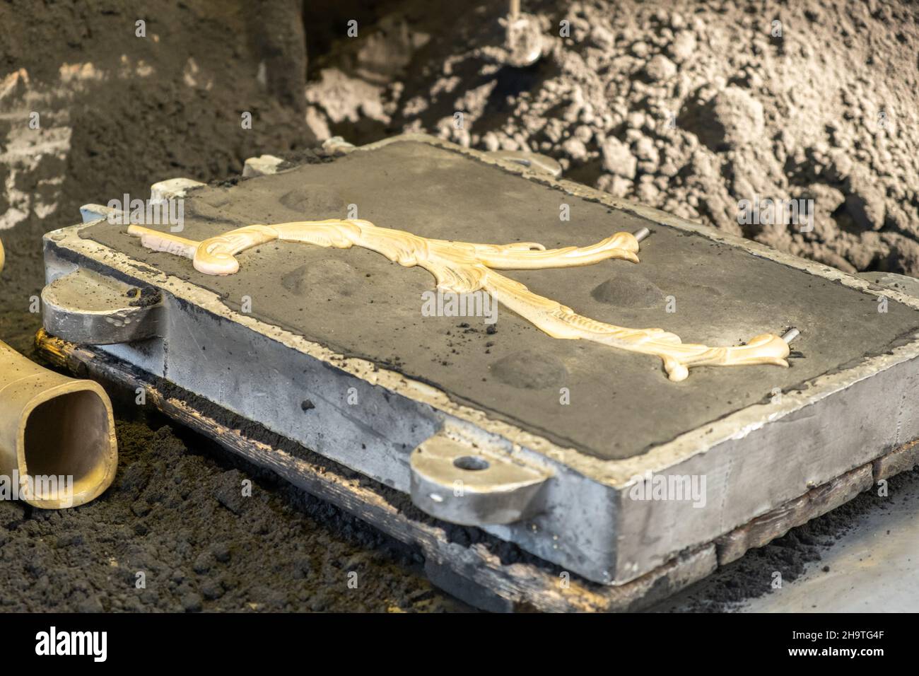 Dekorative Metall Zweig Detail in Form auf Haufen von grauem Pulver in Licht Produktionsanlage Werkstatt extreme aus nächster Nähe geformt Stockfoto