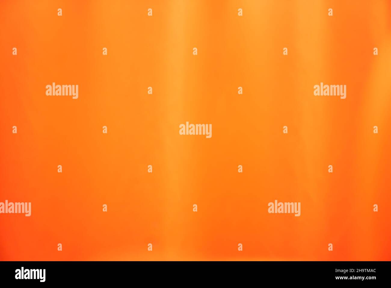 Leuchtender orangefarbener Hintergrund aus Textilmaterial. Qualität mit natürlicher Textur. Hochwertige Fotos Stockfoto