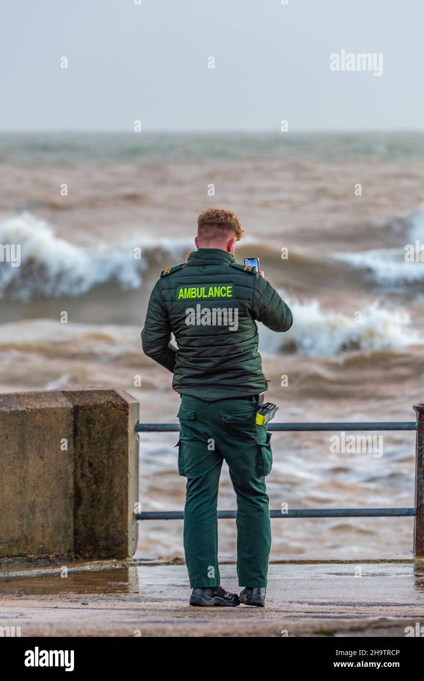 Krankenwagen-Sanitäter beobachten einen Sturm, während sie in der Süßwasserbucht auf der Insel wight stehen, Krankenwagen-Techniker beobachten raue Meere an der Küste. Stockfoto
