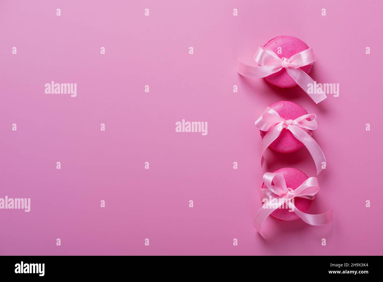 Rosa Makronen auf rosa Hintergrund. Süßer Hintergrund. Stockfoto