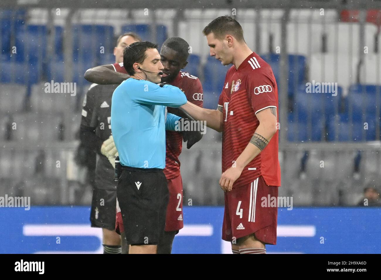 München, Deutschland. 08th Dez 2021. Dayot UPAMECANO (FC Bayern München) und Niklas SUELE (FC Bayern München) mit Schiedsrichter Ovidiu HATEGAN (ROM). Soccer Champions League Group E/FC Bayern München - FC Barcelona 3-0 am 8th. Dezember 2021, ALLIANZAREN A. Quelle: dpa/Alamy Live News Stockfoto