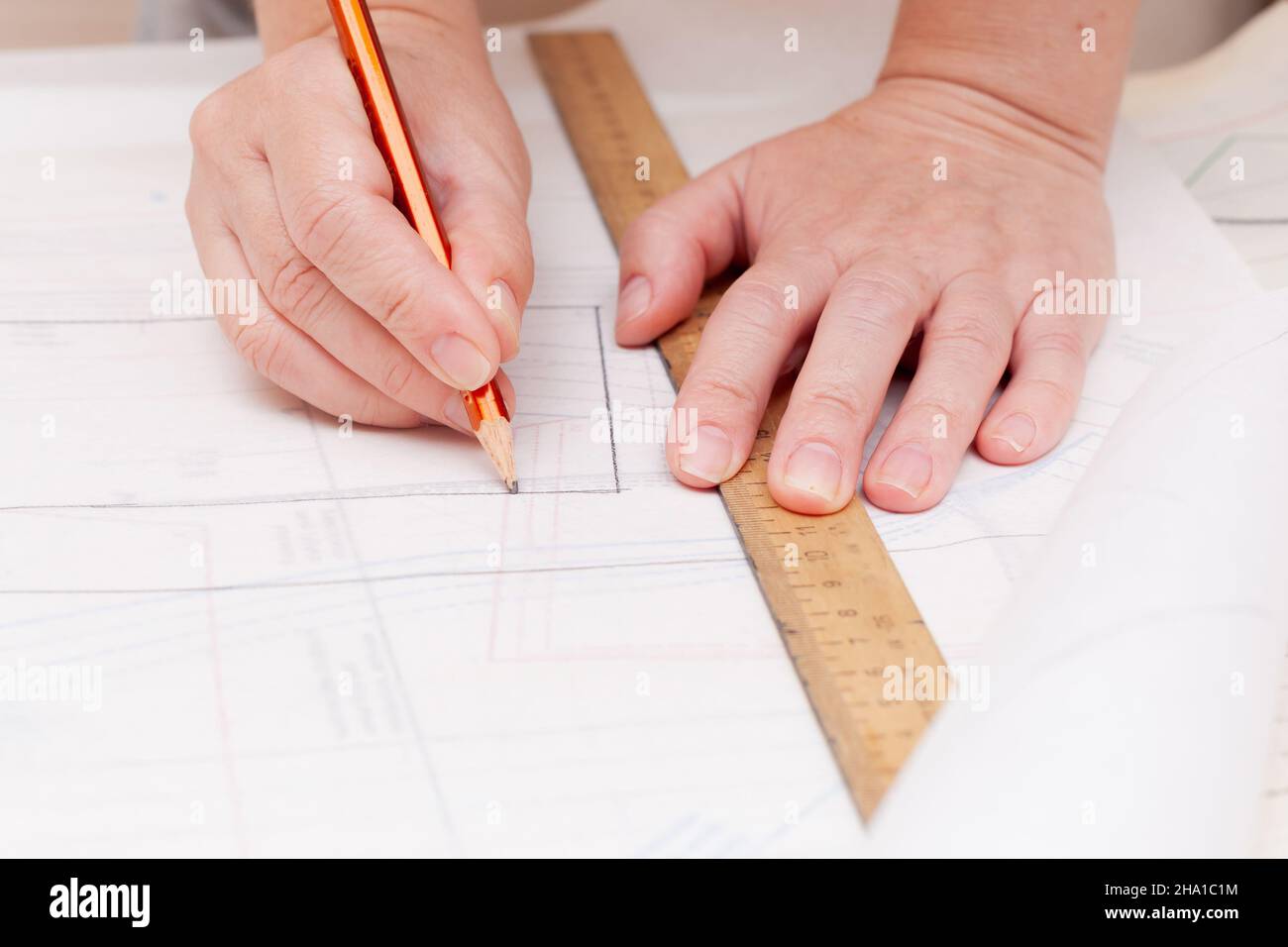Weibliche Hände machen das Layout des Nähmusters auf Papier Stockfoto