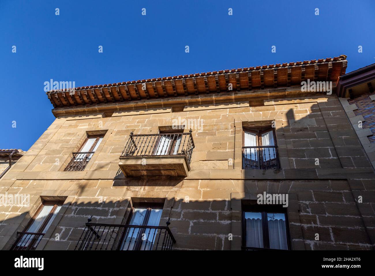 Straße mit historischen Gebäuden im Dorf San Asensio, La Roja Alta, Spanien, zeigt überhängende geschnitzte Holzdachbalken Stockfoto