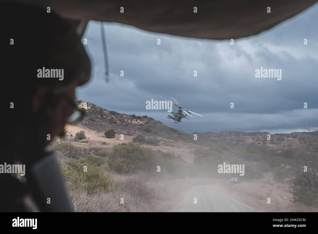 US-Marineinfanteristen mit der 1st Marine Logistics Group navigieren mit der Begleitung von HMLA-267 während einer Konvoi-Trainingsübung in Camp Pendleton, Kalifornien, bergiges Gelände. Oktober 7, 2021. Der Konvoi beinhaltete einen Hinterhalt von gegnerischen Truppe-Rollenspielern, um eine hochbelastende Umgebung zu schaffen, die die Einsatzbereitschaft und die Kampffähigkeiten verbessert. (USA Marine Corps Foto von CPL. William Redding) Stockfoto