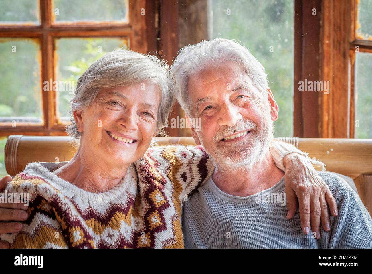 Fröhliches und fröhliches Porträt eines älteren Ehepaares, das zu Hause lächelt und umarmt. Ältere Menschen im Ruhestand Mann und Frau genießen die Zeit zusammen mit Liebe und Freundschaft Stockfoto