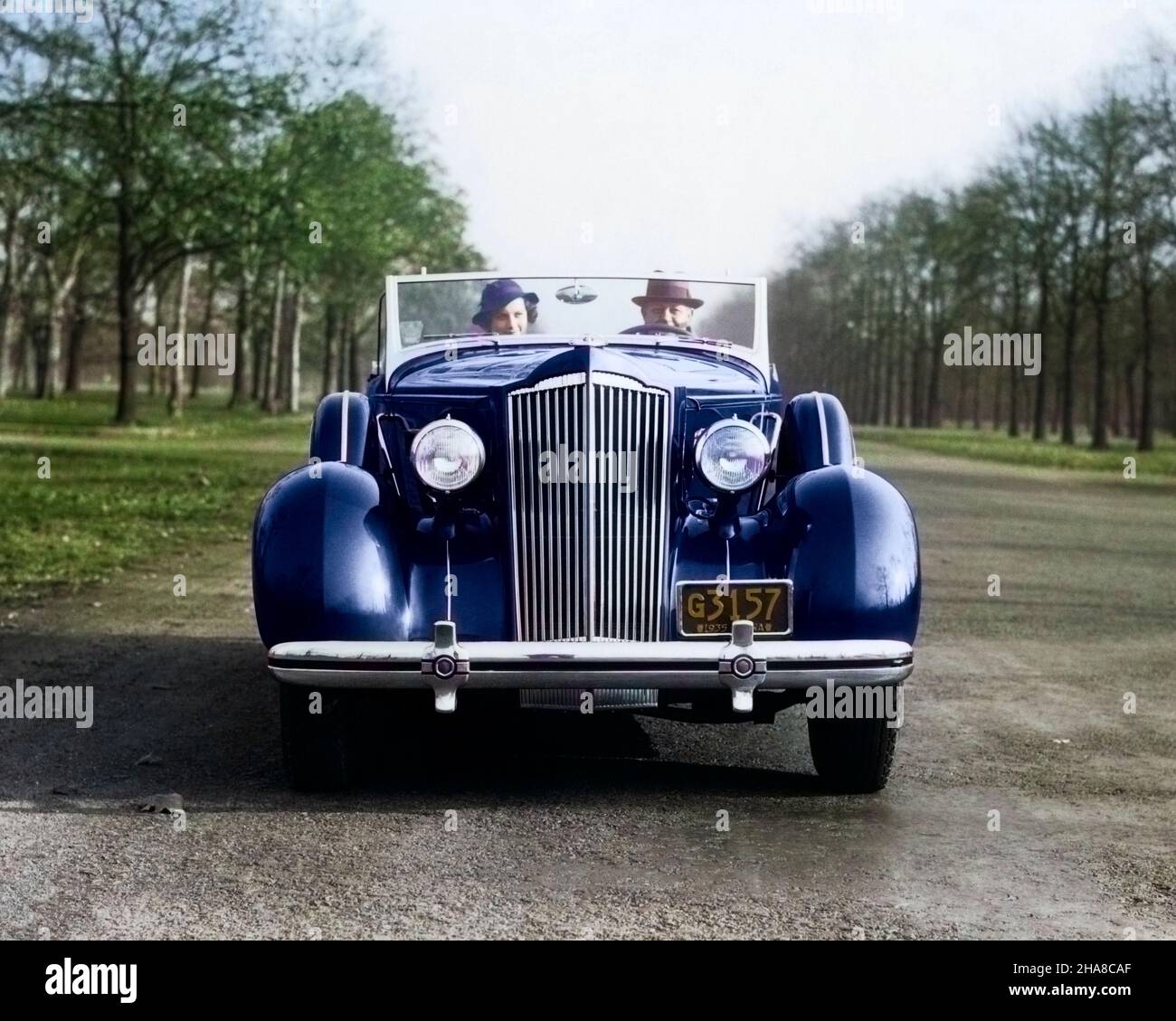 1930S SONNTAG FAHRT PAAR MANN UND FRAU BEIM KAMERAFAHREN 1935 PACKARD CABRIO AUTO - M2769C HAR001 HARS EHEPARTNER EHEMÄNNER ERWACHSEN TRANSPORT KOPIEREN RAUM FREUNDSCHAFT DAMEN PERSONEN ERWACHSEN AUTO MÄNNER TRANSPORT PARTNER AUGE KONTAKT KOPF UND SCHULTERN KRAFTFAHRZEUG AUTOS IM AUTOVERKEHR SONNTAG FAHREN AUTOS MOBILITÄT FAHRZEUGE 1935 PACKARD ZWEISAMKEIT FRAUEN JUNGER ERWACHSENER MANN JUNGER ERWACHSENER FRAU KAUKASISCHE ETHNIE HAR001 ALTMODISCH Stockfoto