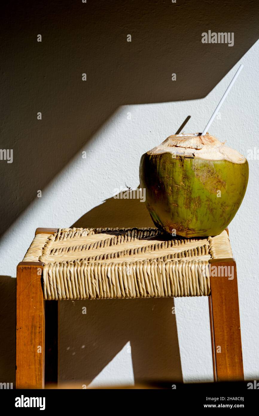 Frische Kokosnuss auf Hocker mit Schatten Stockfoto