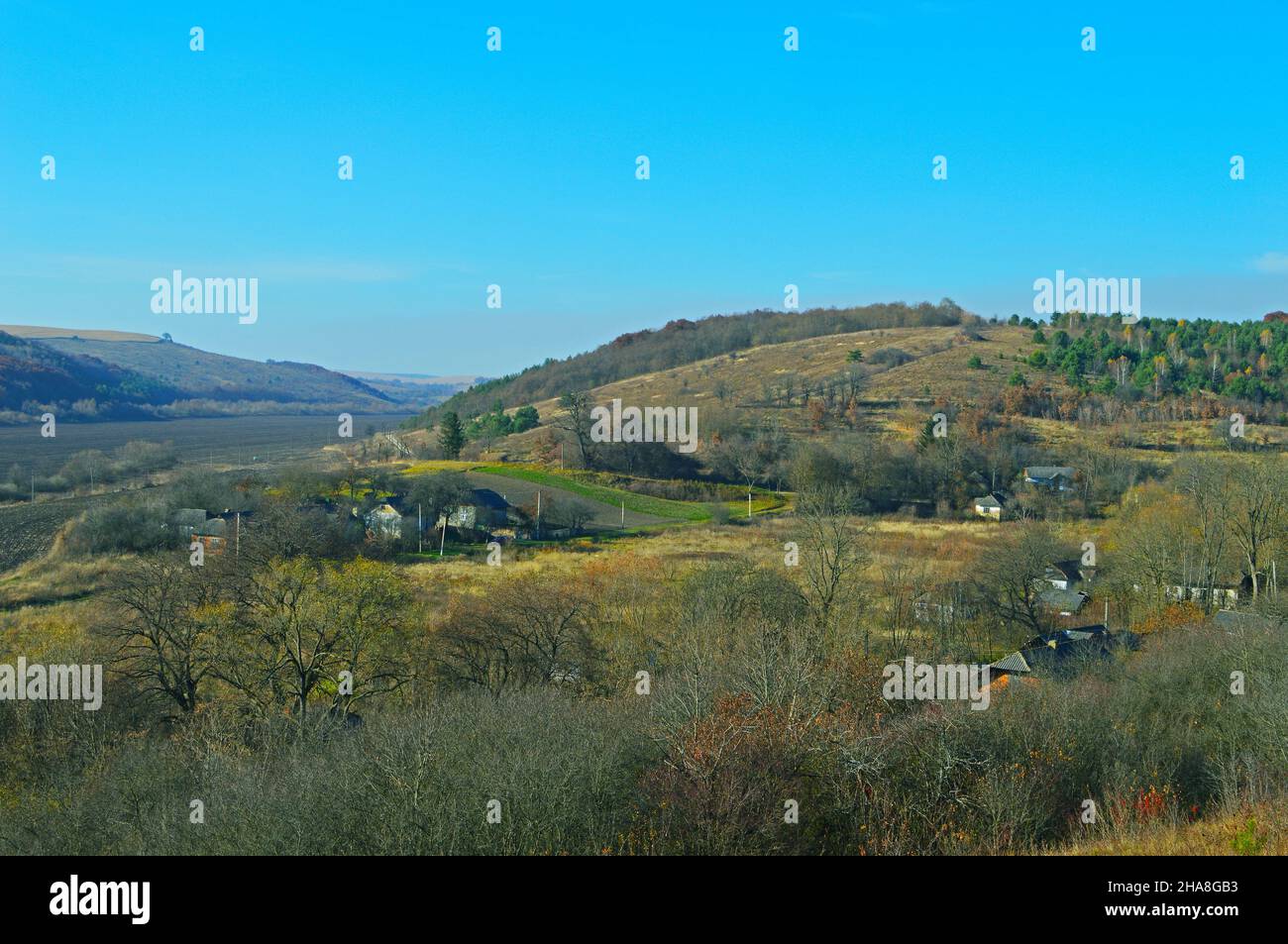 Landschaft mit einem kleinen Dorf auf hügeligem Gelände Stockfoto