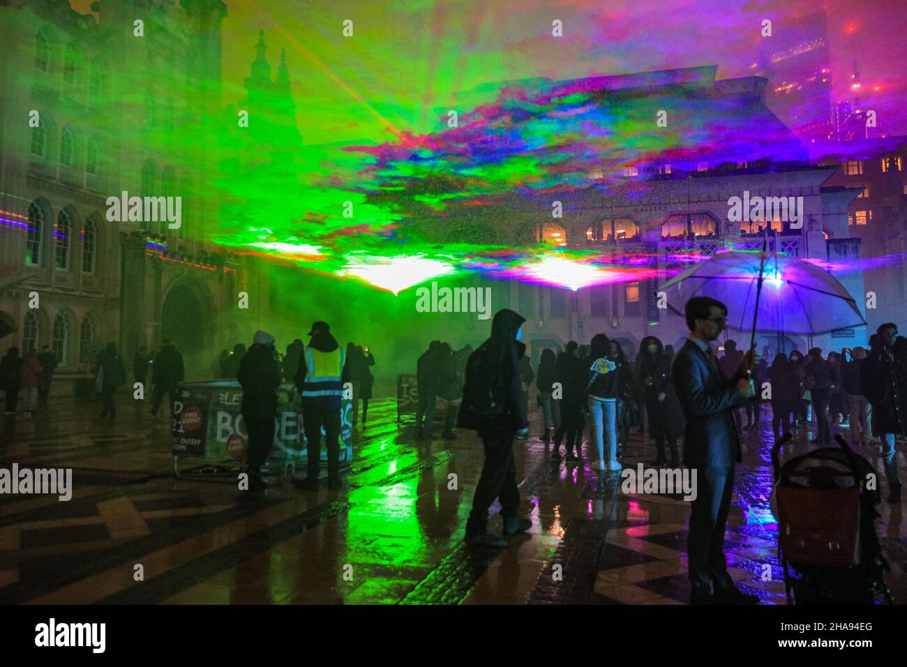 Guildhall Yard, London, Großbritannien. 11th Dez 2021. Die Menschen genießen den ausverkauften Eröffnungsabend. Dan Archer's spektakuläre Borealis, eine immersive Installation, die von den Nordlichtern inspiriert wurde, erleuchtet den Himmel über dem Guildhall Yard im Herzen der City of London. Die Installation ist kostenlos, aber mit einem Ticket ausgestattet, um eine soziale Distanzierung zu gewährleisten. Es ist Teil der Winterlichtsaison der Kampagne ‘Let's Do London' des Bürgermeisters von London und kann bis zum 22nd. Dezember besichtigt werden. Kredit: Imageplotter/Alamy Live Nachrichten Stockfoto