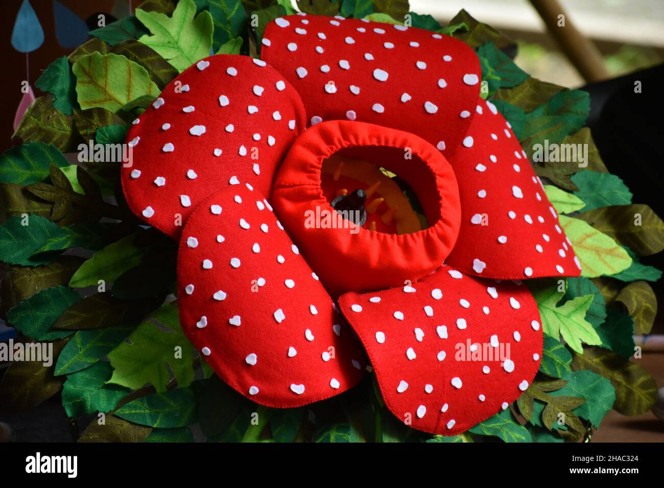 Flockenschmuck aus Rafflesia-Blüten auf dekorativem Regenschirm. Stockfoto