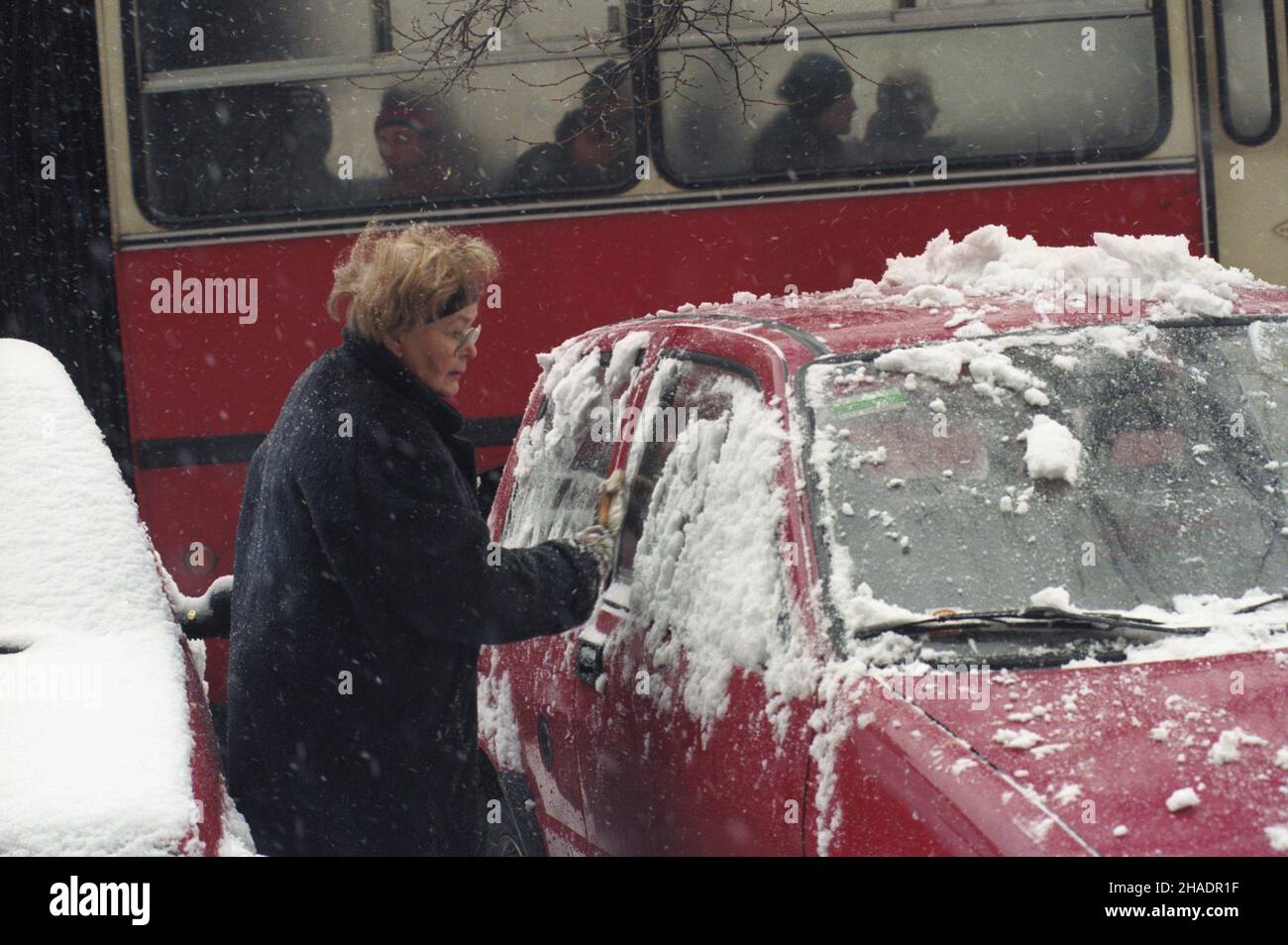 Warszawa 22.12.1993. Odœnie¿anie samochodu zaparkowanego w Alejach Ujazdowskich (Œródmieœcie Po³udniowe). mta PAP/Andrzej Rybczyñski Warschau 22. Dezember 1993. Eine Frau, die Schnee aus einem Auto in der Aleje Ujazdowskie Street entfernt. mta PAP/Andrzej Rybczynski Stockfoto