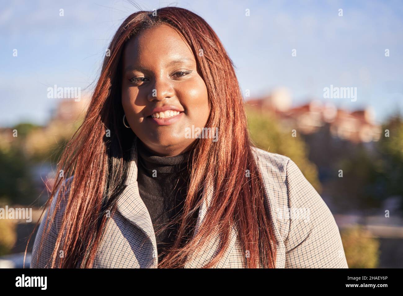 Porträt einer glücklichen jungen afroamerikanischen Frau mit lächelndem Gesichtsausdruck und Kopierraum. Ein Porträt von echten Menschen kolumbianischer Herkunft. Stockfoto