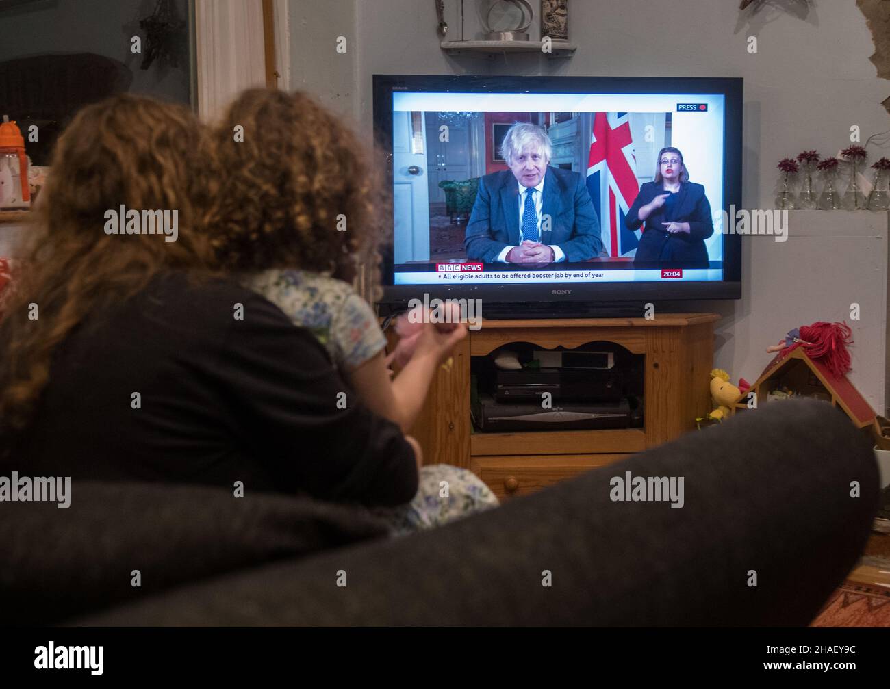 Boris Johnson PM hat im Fernsehen in einem Wohnzimmer fotografiert, als er vor Weihnachten Familien im ganzen Land anspricht, nachdem die Covid-Alarmstufe auf Stufe vier angehoben wurde. Stockfoto