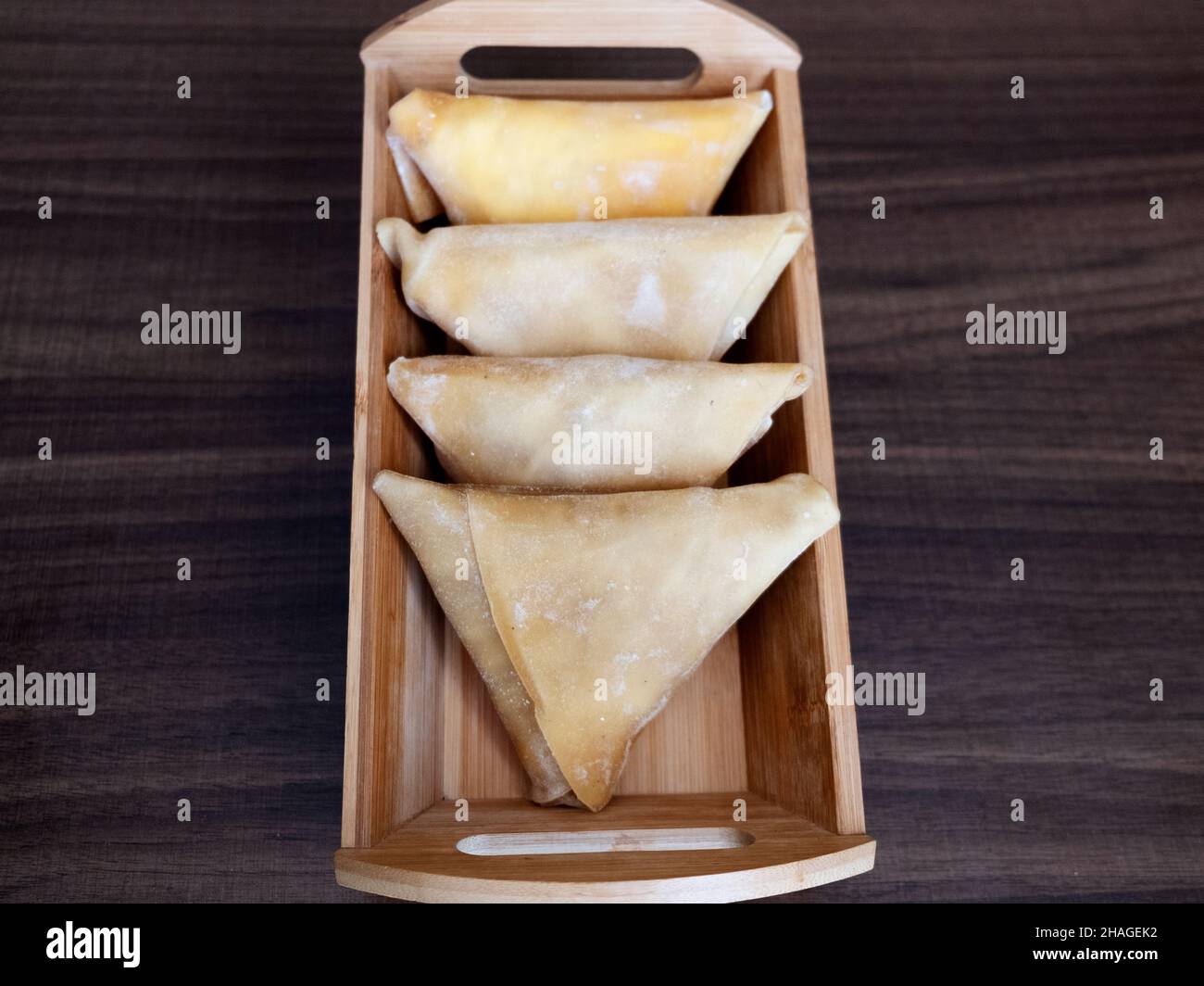 Pestil, Fruchtfleisch, vier dreieckige türkische Traubenpestil in einer rechteckigen Holzkiste Stockfoto