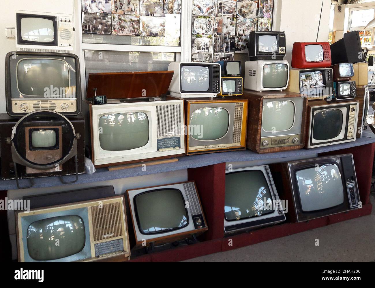 Eine Reihe von verschiedenen veralteten antiken Fernsehern, die für die Geschichte übereinander gestapelt wurden Stockfoto