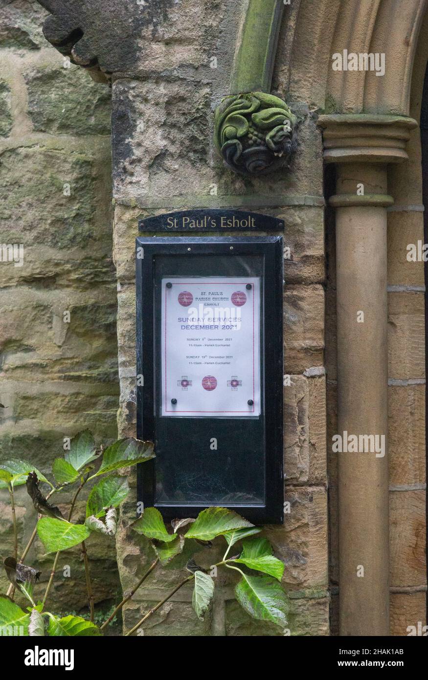 Ein Kirchentafel an der Seite der Tür der St. Paul's Church Esholt. Stockfoto