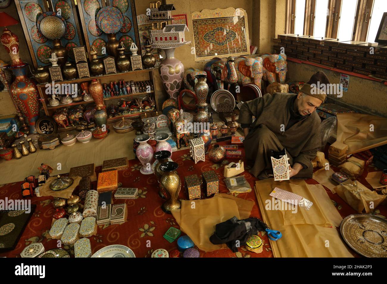 Srinagar, Indien. 13th Dez 2021. Kaschmiri-Handwerker verpacken Weihnachtsschmuck vor den Weihnachtsfeiern in Srinagar, Kaschmir, am 13. Dezember 202.Kaschmiri-muslimische Künstler sind damit beschäftigt, verschiedene festliche Papiermaché-Produkte und Dekorationsartikel zu verpacken, um sie in die USA, das Vereinigte Königreich, Frankreich, Deutschland und viele andere Teile der Welt zu exportieren. (Foto: Sajad Hameed/Pacific Press/Sipa USA) Quelle: SIPA USA/Alamy Live News Stockfoto