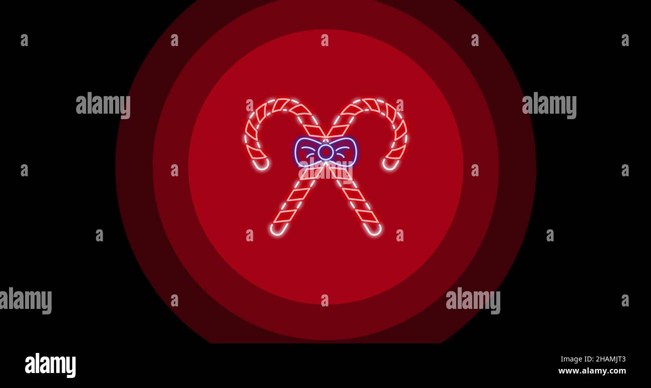 Digitales Komposit aus beleuchteten Zuckerstöcken auf rotem kreisförmigem Muster auf schwarzem Hintergrund Stockfoto