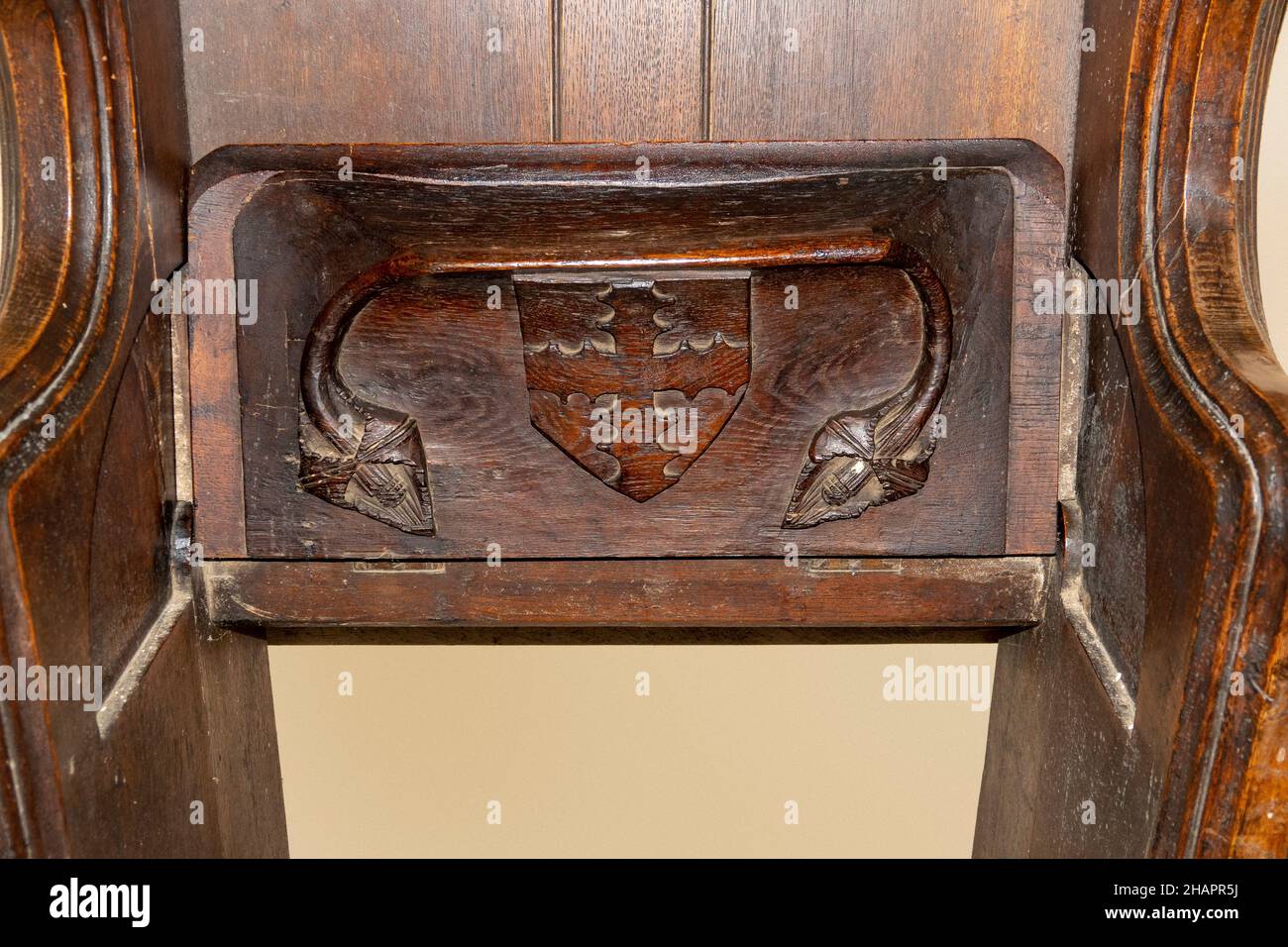 Ein Wappen in einem Schild, das auf der Unterseite eines misericord-Kirchsitzes in aufrechter Position geschnitzt ist. In St. Mary of the Assumption, Ufford, Suffolk Stockfoto