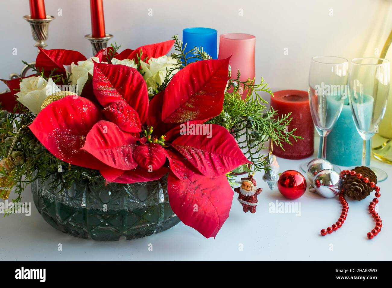 Einstellung weihnachtsessen Tisch oder Neujahr Nacht mit besonderen Ornamenten, Weihnachtsstern Blume, Champagner-Flasche und Kerzen Stockfoto