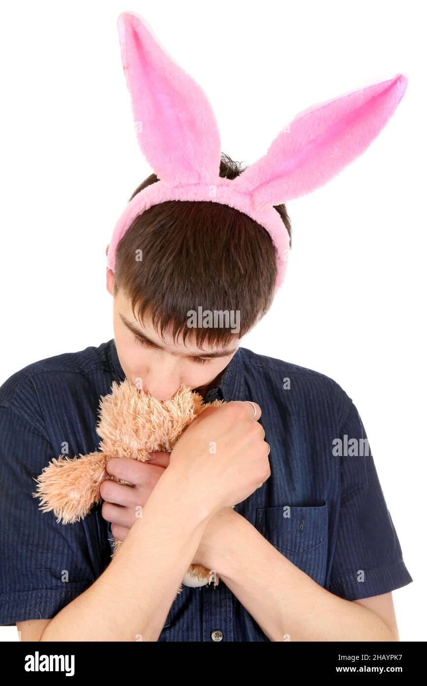 Kindliche Teenager mit Hasenohren und Teddybär isoliert auf dem weißen Hintergrund Stockfoto